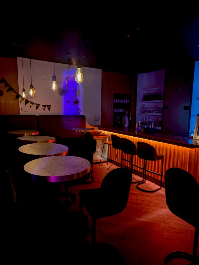 Low-lit seating area in Adrian's Bar speakeasy, Glasgow